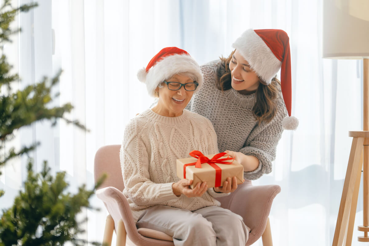 Woman and daughter giving gifts during holidays